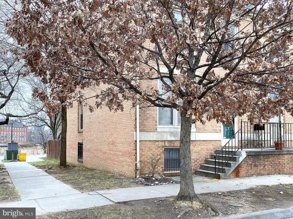 an empty room with windows cabinet and mirror