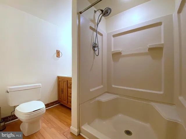 a bathroom with a toilet a sink and mirror