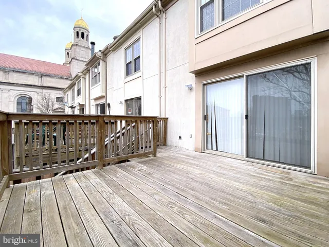 a view of a house with backyard and deck