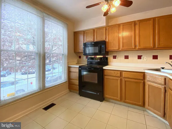 a kitchen with a sink stove and microwave