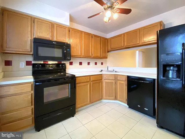 a kitchen with a sink stainless steel appliances and cabinets