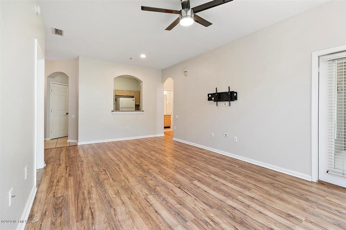 10550 Baymeadows Road, Unit 607 Jacksonville, FL 32256 - Photo 3 of 15 an empty room with wooden floor and windows