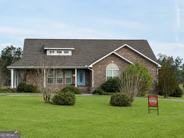a front view of house with yard and green space