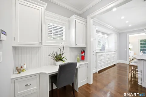 a kitchen with granite countertop a sink cabinets and appliances