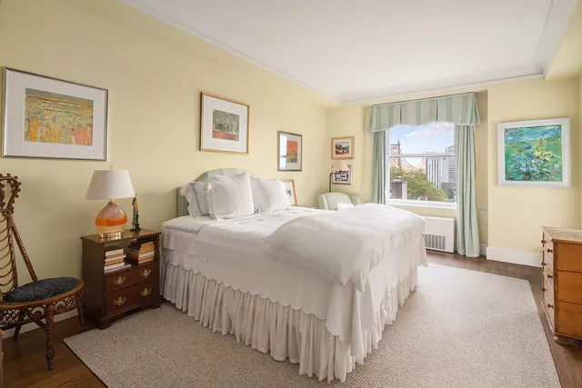 a view of a hallway with wooden floor and furniture
