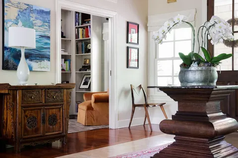a living room with furniture a potted plant and a fireplace
