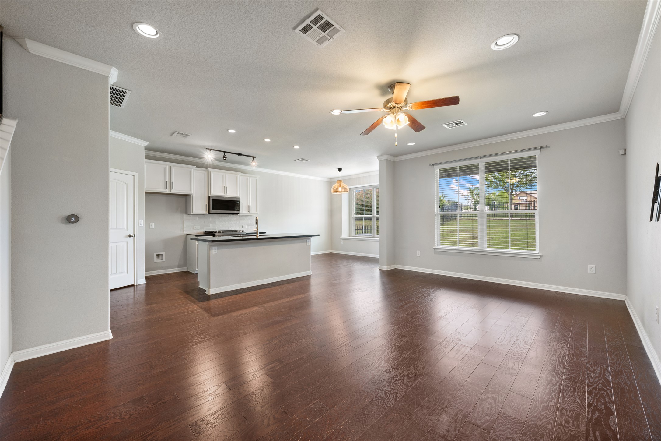 211 Parable Cove Pflugerville, TX 78660 - Photo 5 of 40 Open-concept living area featuring wood-finish flooring, recessed lighting, and a ceiling fan