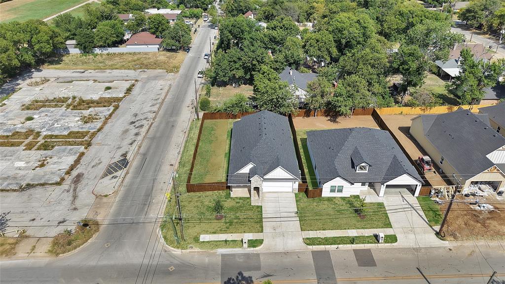 801 Tierney Road Fort Worth, TX 76112 - Photo 28 of 30 New construction residence featuring a dark shingle roof, light-colored siding, an attached garage, and a concrete driveway