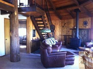 25160 Cougar Road Idyllwild, CA 92549 - Photo 4 of 17 a living room with couches chairs and stair