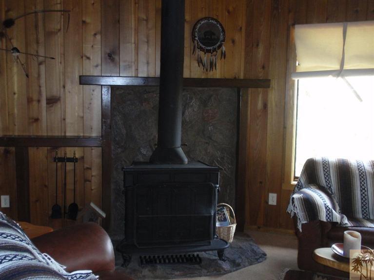 25160 Cougar Road Idyllwild, CA 92549 - Photo 7 of 17 a living room with furniture and a fireplace