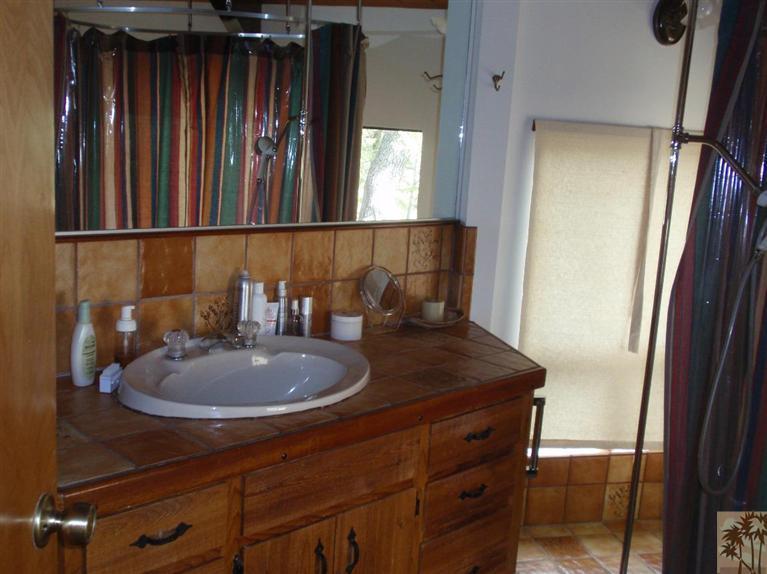 25160 Cougar Road Idyllwild, CA 92549 - Photo 9 of 17 a bathroom with a sink a mirror and vanity