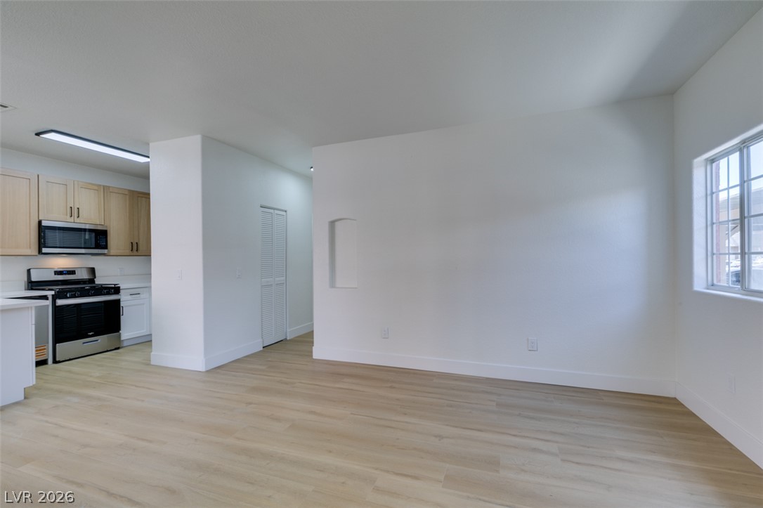 4730 East Craig Road, Unit 1085 Las Vegas, NV 89115 - Photo 23 of 23 A streamlined kitchen flows into an open living area with durable wood-look flooring.