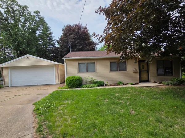 a front view of house with yard and green space