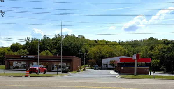 an aerial view of a house with garden space and street view