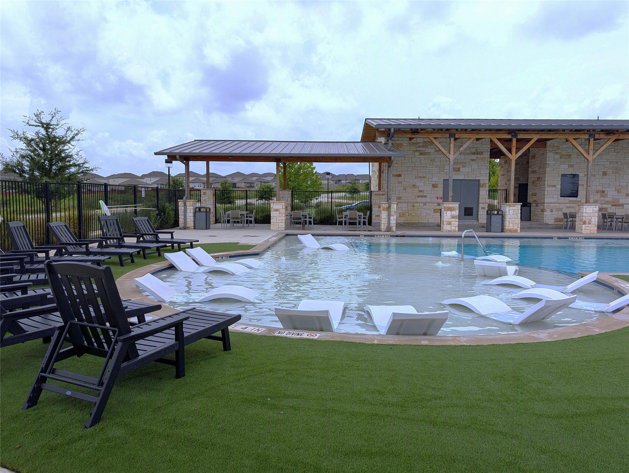 6509 Rounded Pebble Lane Buda, TX 78610 - Photo 38 of 40 Beached area with lounge chairs - community pool