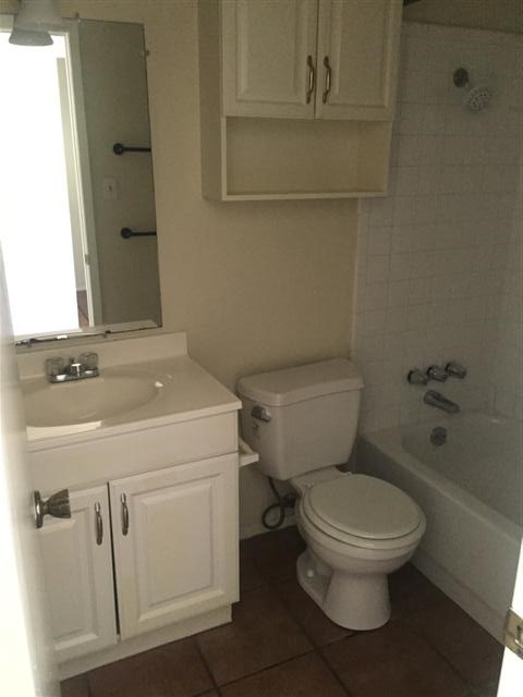 630 Maiden Lane, Unit A Austin, TX 78705 - Photo 9 of 12 a white toilet sitting next to a bathroom sink