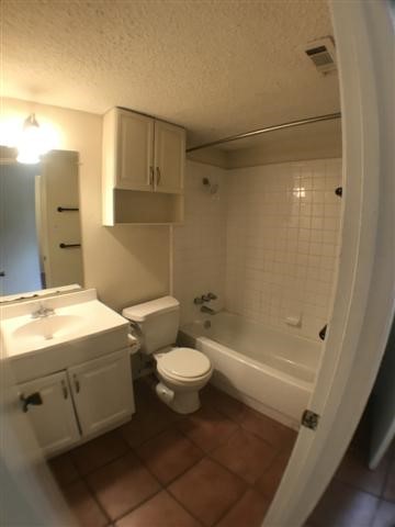 630 Maiden Lane, Unit A Austin, TX 78705 - Photo 10 of 12 a bathroom with a sink a toilet and shower