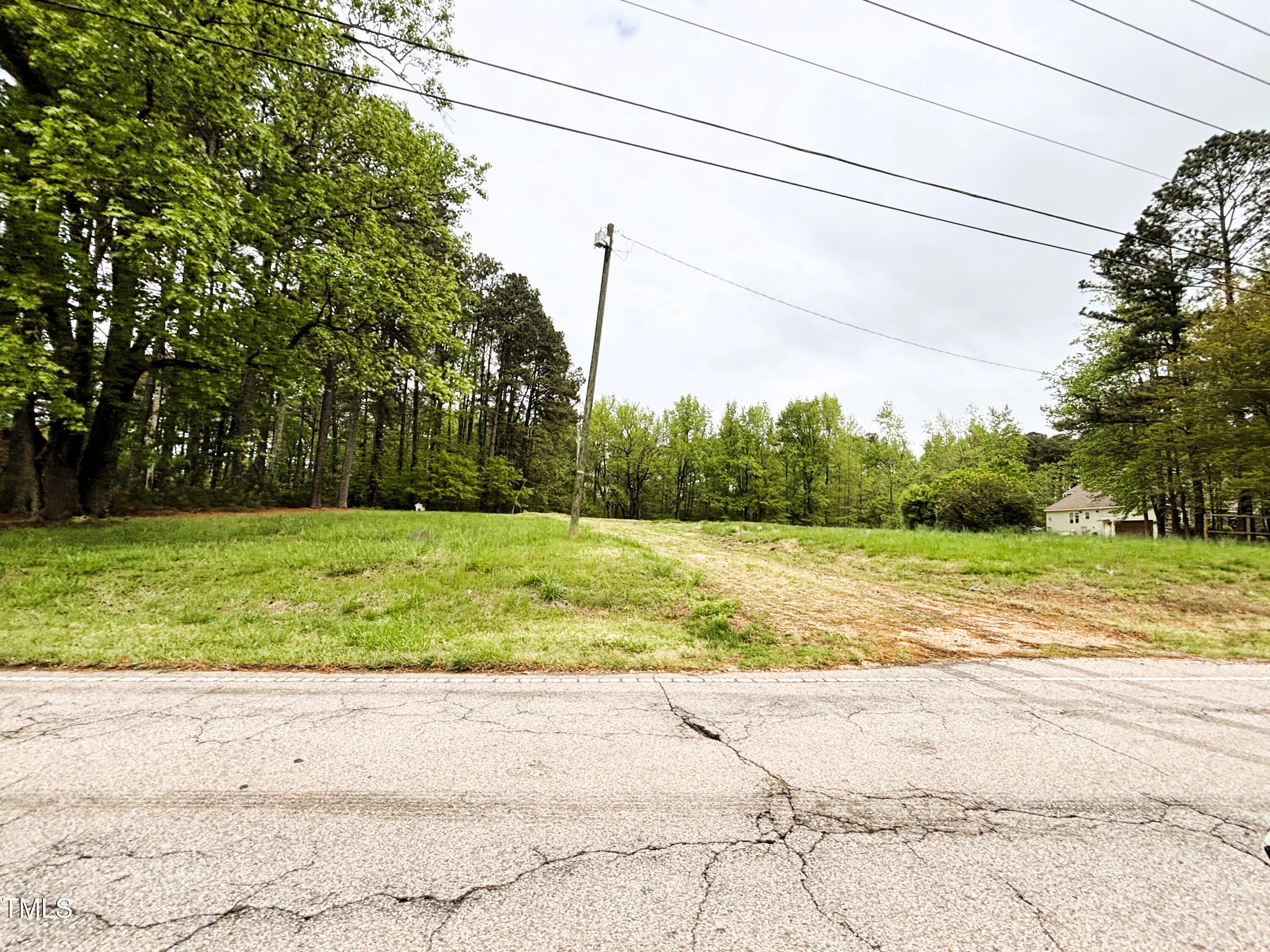 1712 Avent Ferry Road Holly Springs, NC 27540 - Photo 4 of 6 a view of a yard with large trees