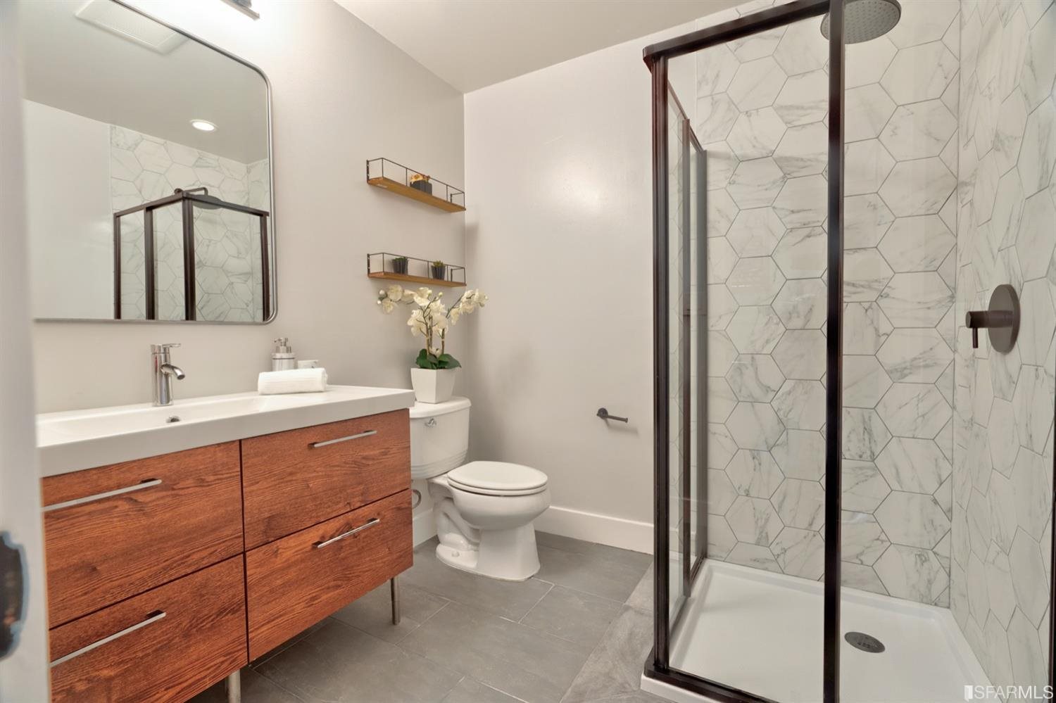 15 Perego Terrace, Unit 2 San Francisco, CA 94131 - Photo 26 of 45 a bathroom with a double vanity sink toilet and shower