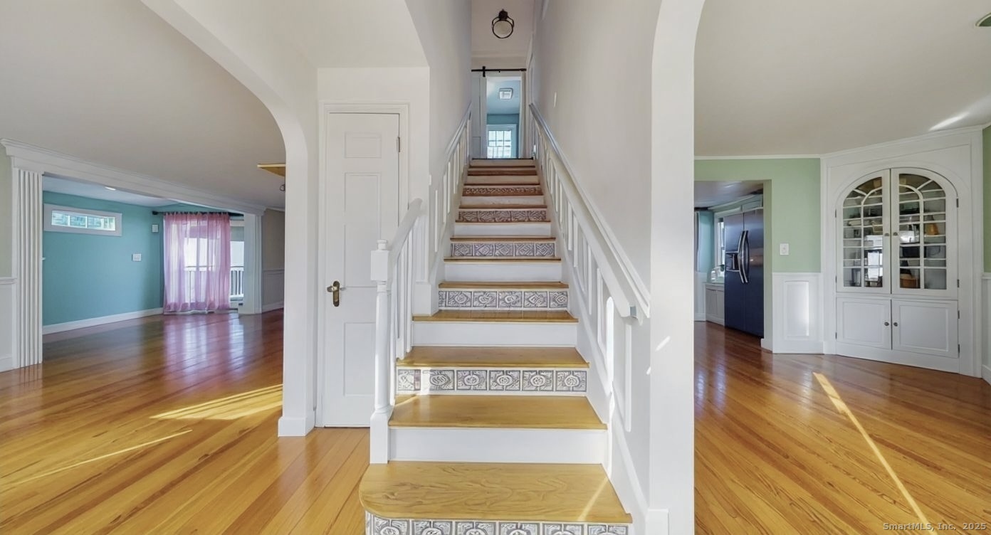 70 Lawlor Street Waterbury, CT 06708 - Photo 12 of 39 a view of a hallway view with wooden floor and staircase