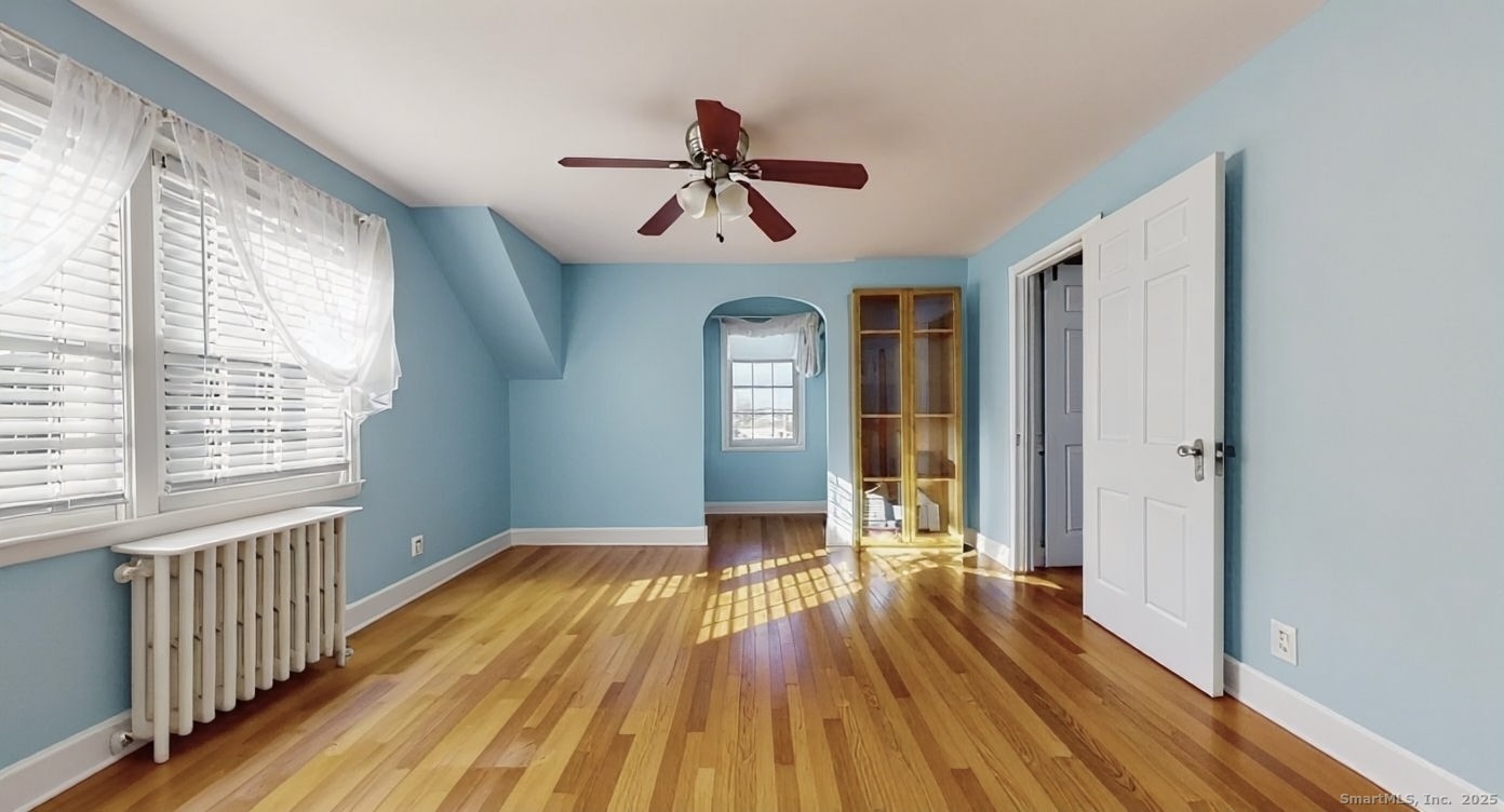 70 Lawlor Street Waterbury, CT 06708 - Photo 14 of 39 a view of a room with wooden floor ceiling fan and windows