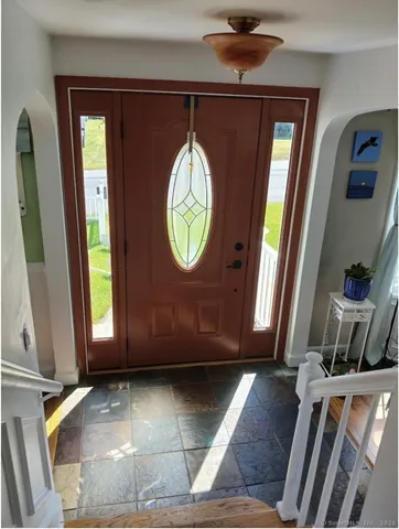 a view of an entryway with wooden floor