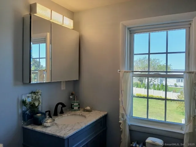 a kitchen with a sink a window and cabinets