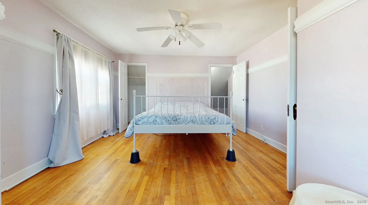 70 Lawlor Street Waterbury, CT 06708 - Photo 17 of 39 a bedroom with a bed and a chandelier