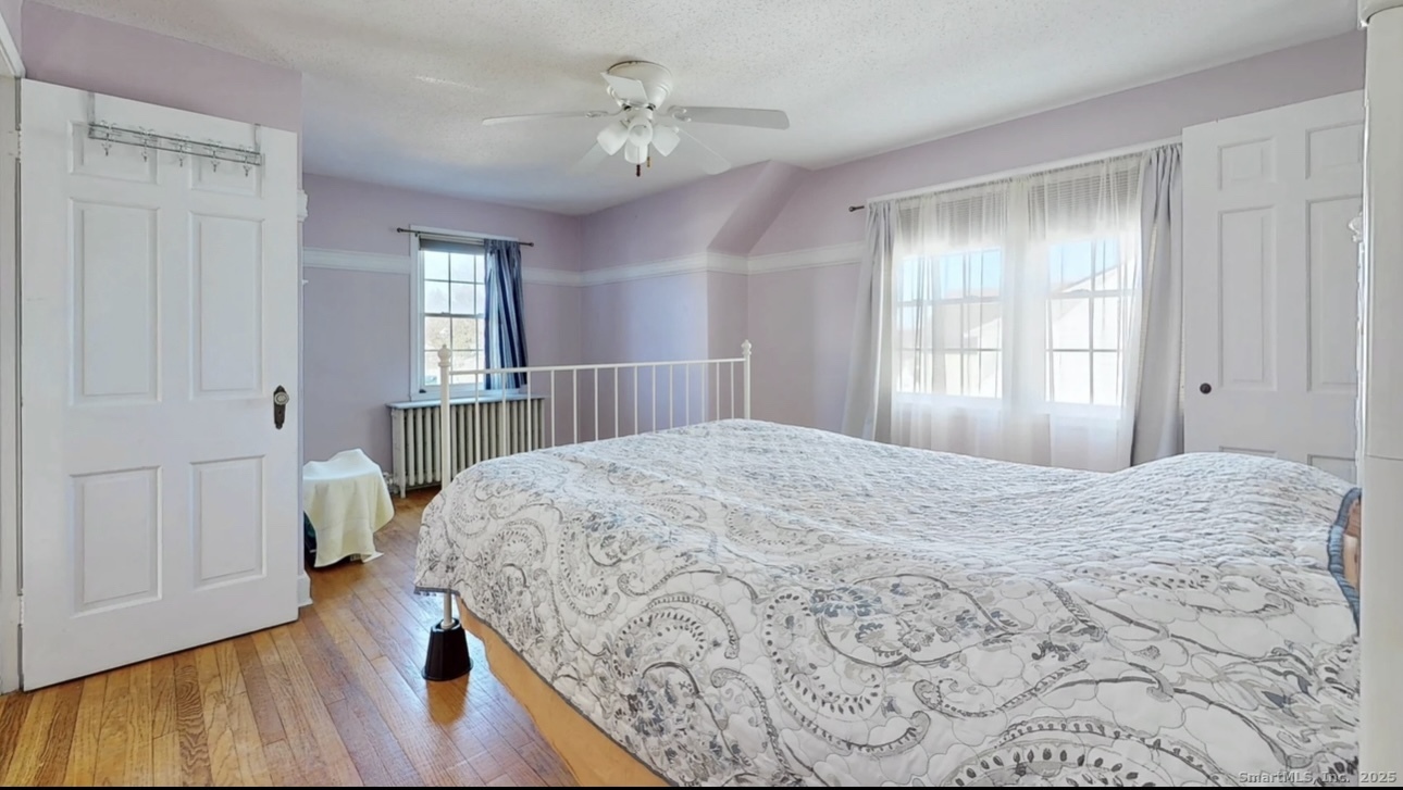 70 Lawlor Street Waterbury, CT 06708 - Photo 18 of 39 a bedroom with a bed and wooden floor