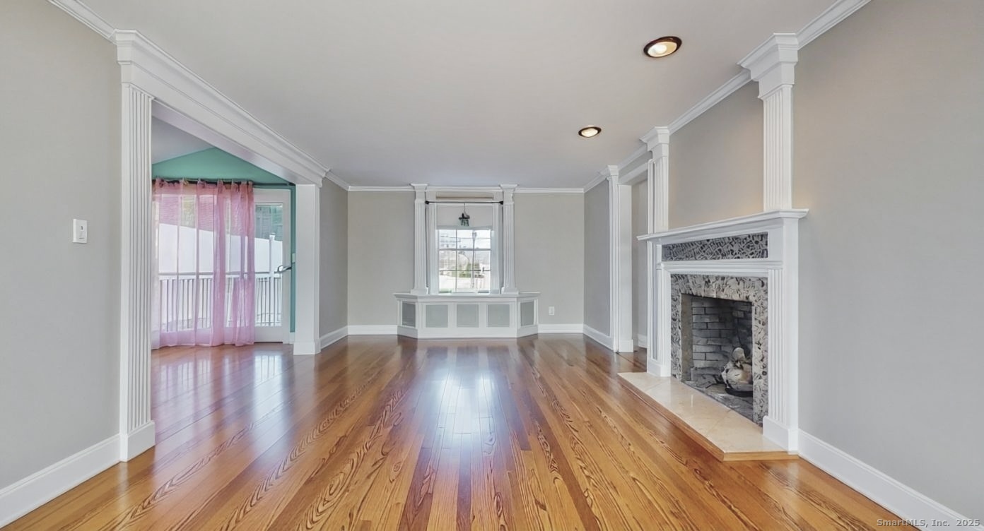 70 Lawlor Street Waterbury, CT 06708 - Photo 2 of 39 a view of livingroom with fireplace wooden floor and window