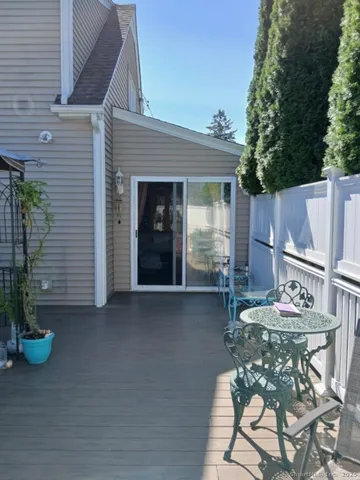 a view of a patio with table and chairs and potted plants