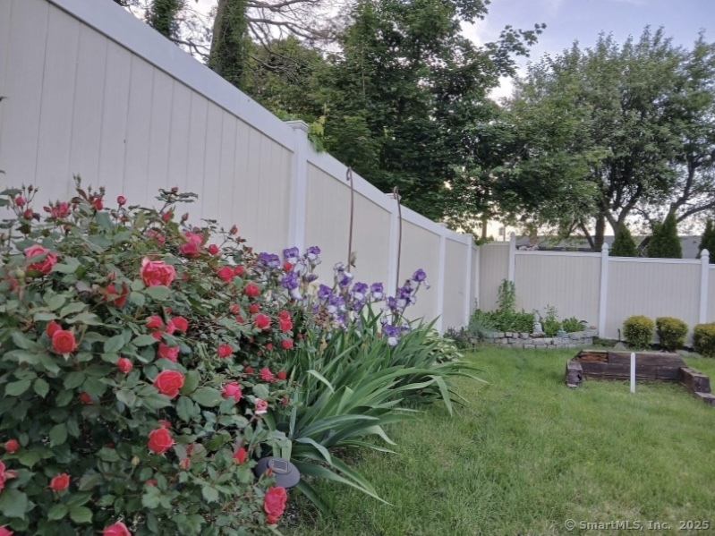 70 Lawlor Street Waterbury, CT 06708 - Photo 29 of 39 a backyard of a house with table and chairs and potted plants