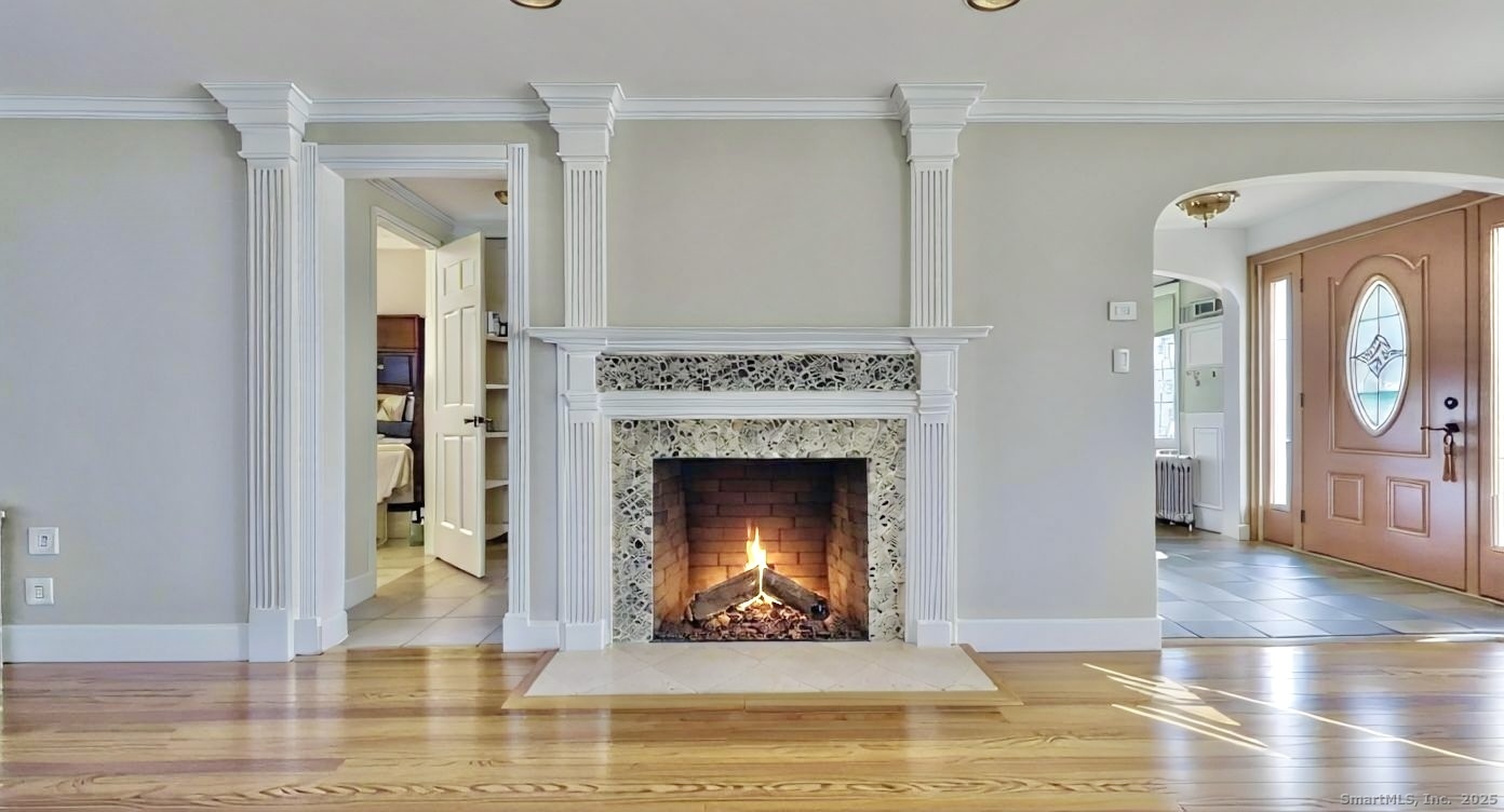70 Lawlor Street Waterbury, CT 06708 - Photo 3 of 39 a living room with a fireplace and a wooden floor