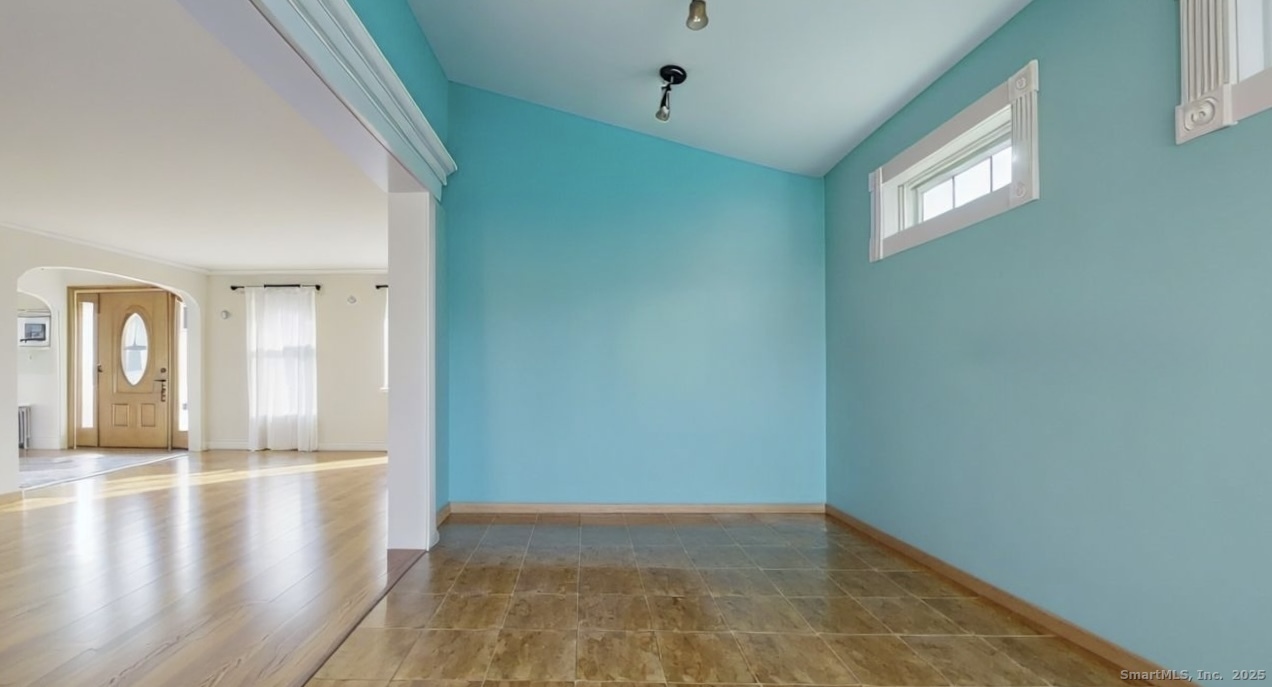 70 Lawlor Street Waterbury, CT 06708 - Photo 9 of 39 a view of an empty room with window and wooden floor