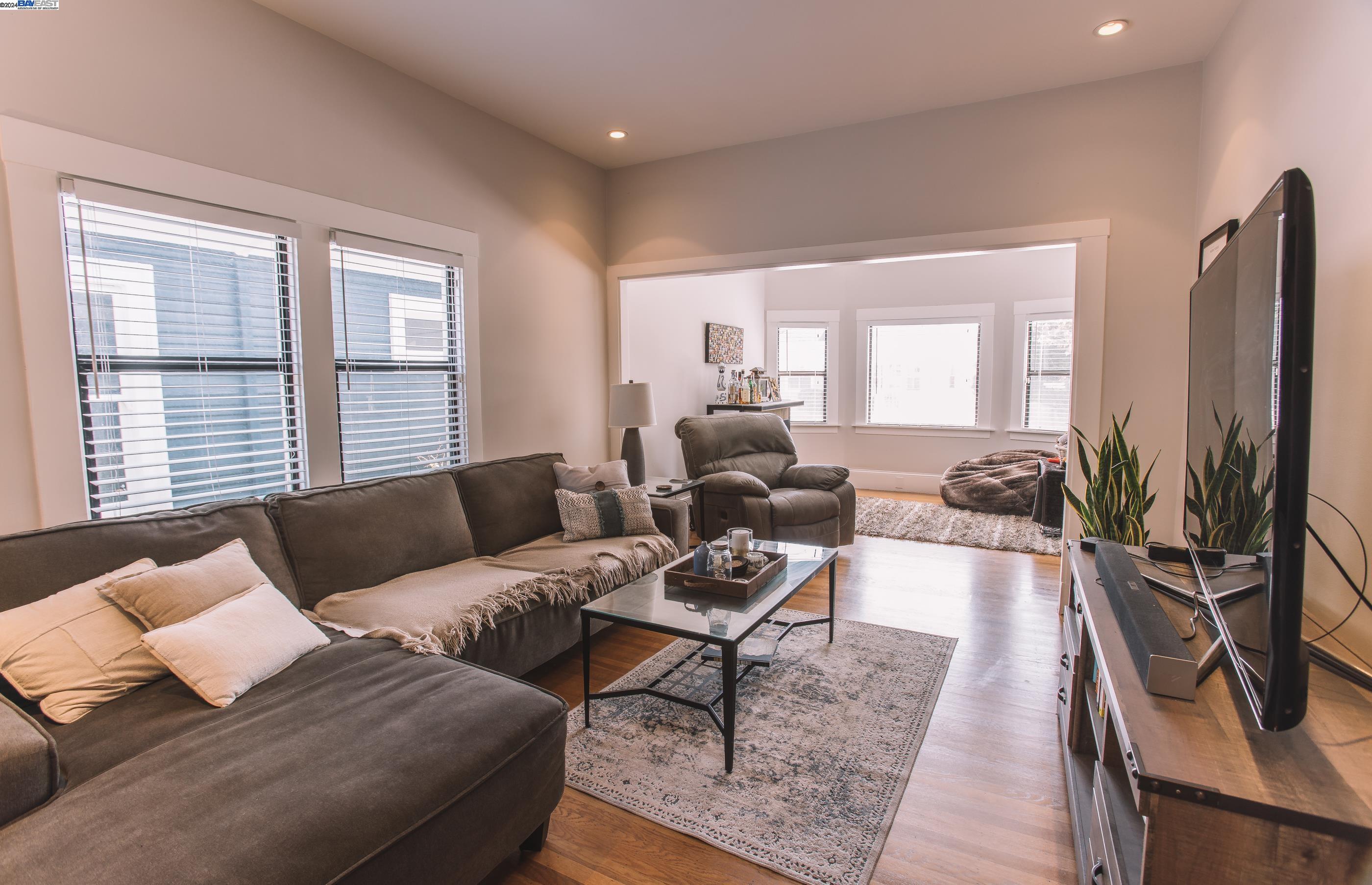 4113 Gilbert Street Oakland, CA 94611 - Photo 3 of 22 a living room with furniture wooden floor and a large window