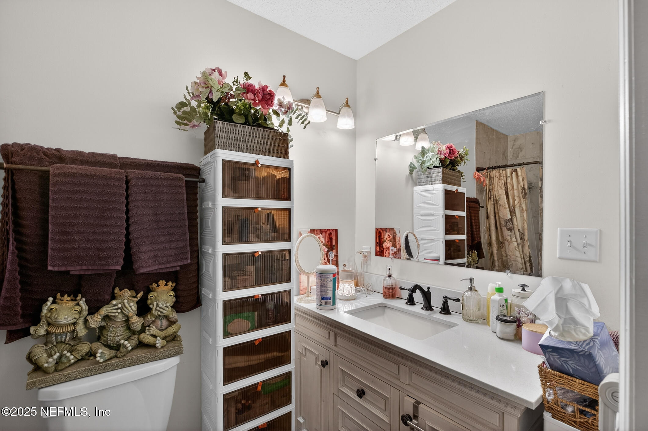 44108 Becker Avenue Callahan, FL 32011 - Photo 21 of 28 a bathroom with a double vanity sink and a mirror