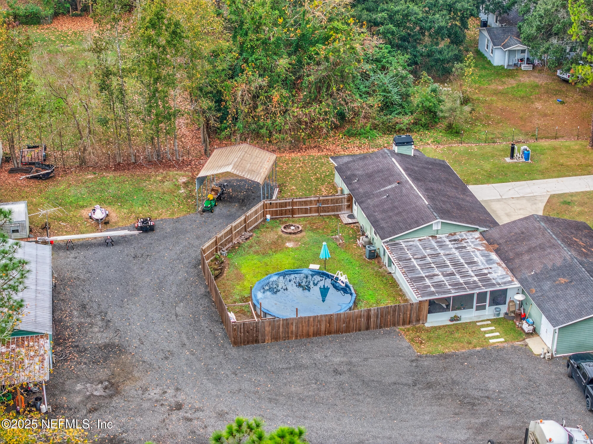 44108 Becker Avenue Callahan, FL 32011 - Photo 26 of 28 an aerial view of a house with swimming pool and large trees