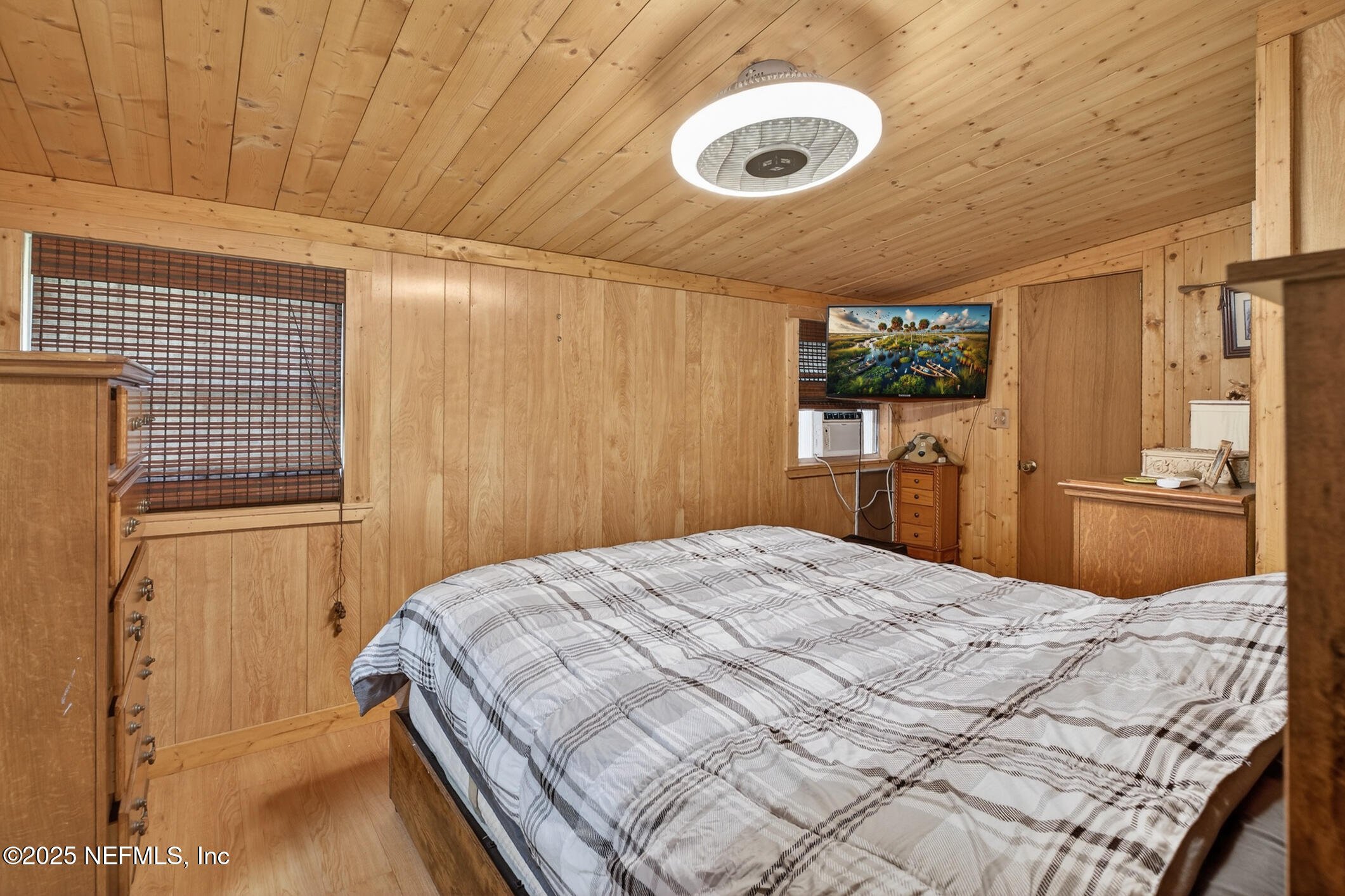 44108 Becker Avenue Callahan, FL 32011 - Photo 10 of 28 a bedroom with a bed and a flat screen tv