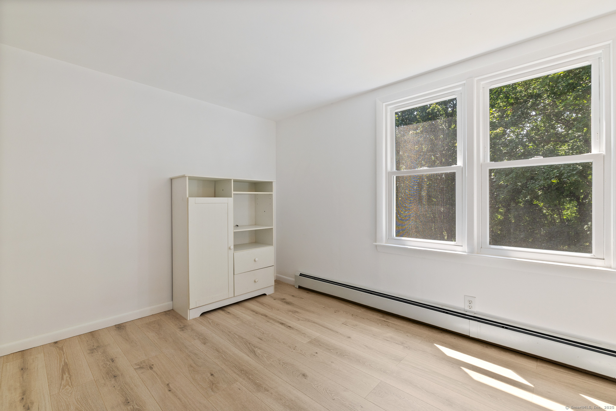 24 Pine Street Waterford, CT 06385 - Photo 12 of 39 an empty room with wooden floor and windows