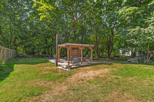 a view of a house with backyard and sitting area