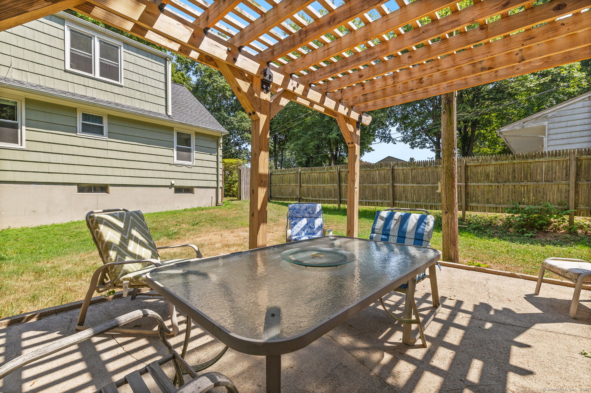 24 Pine Street Waterford, CT 06385 - Photo 27 of 39 a view of a patio with table and chairs with wooden floor and fence