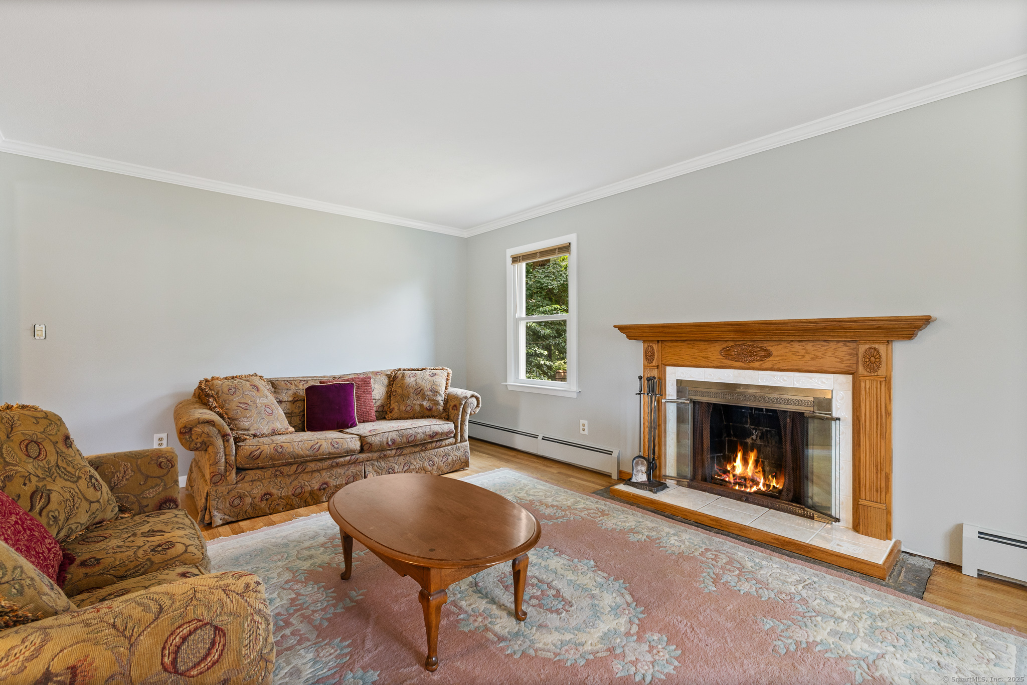 24 Pine Street Waterford, CT 06385 - Photo 36 of 39 a living room with furniture and a fireplace