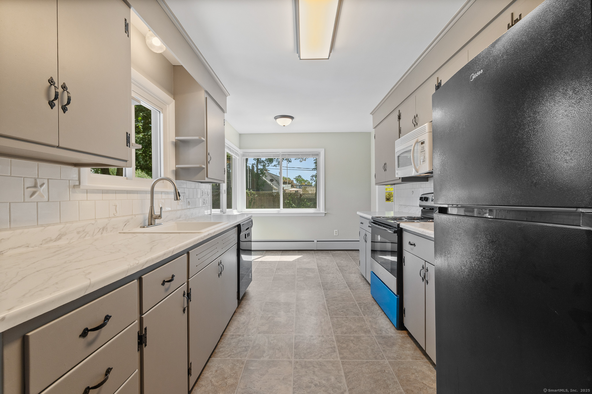 24 Pine Street Waterford, CT 06385 - Photo 37 of 39 a kitchen with a sink a refrigerator and a window