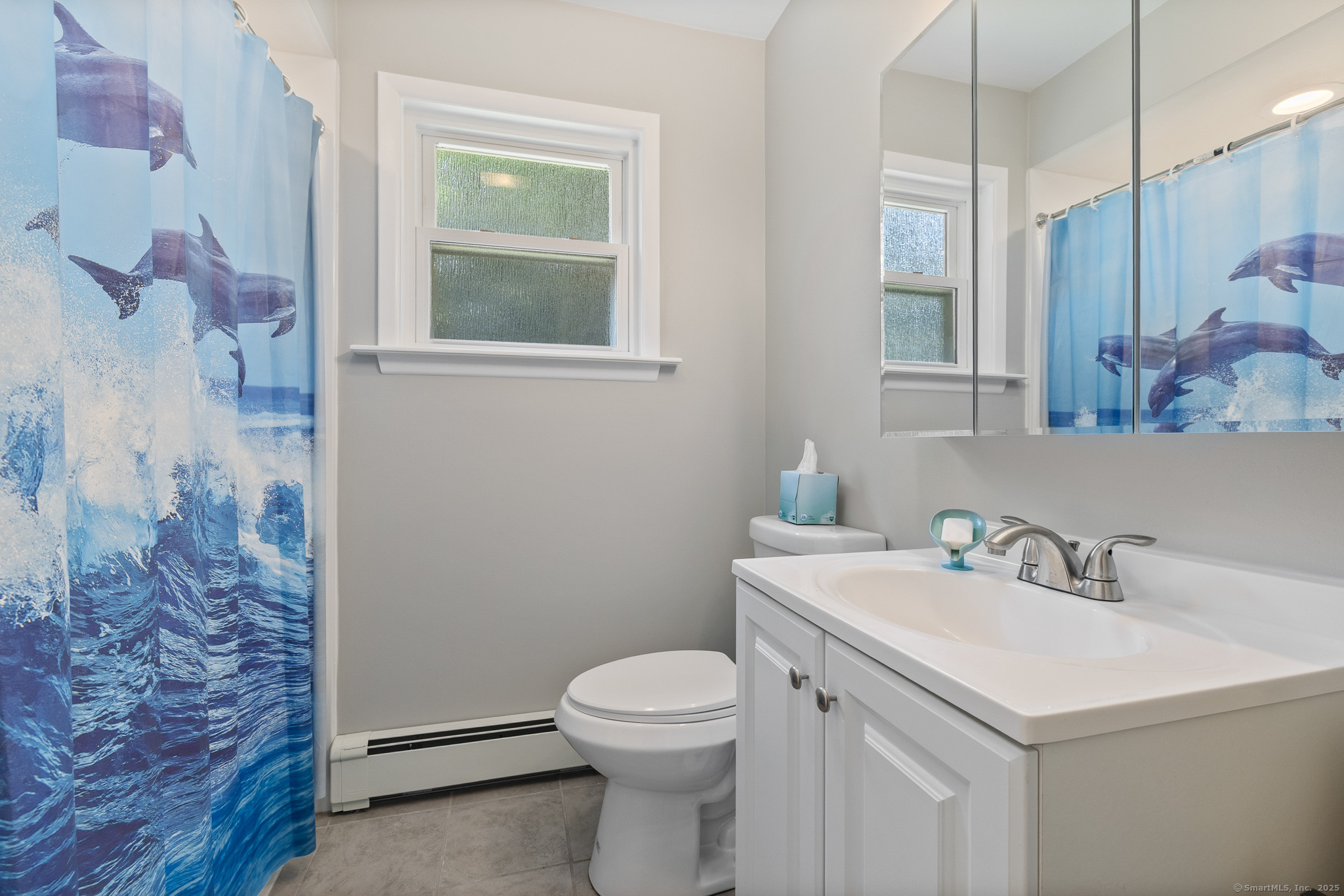 24 Pine Street Waterford, CT 06385 - Photo 39 of 39 a bathroom with a sink a toilet and a mirror