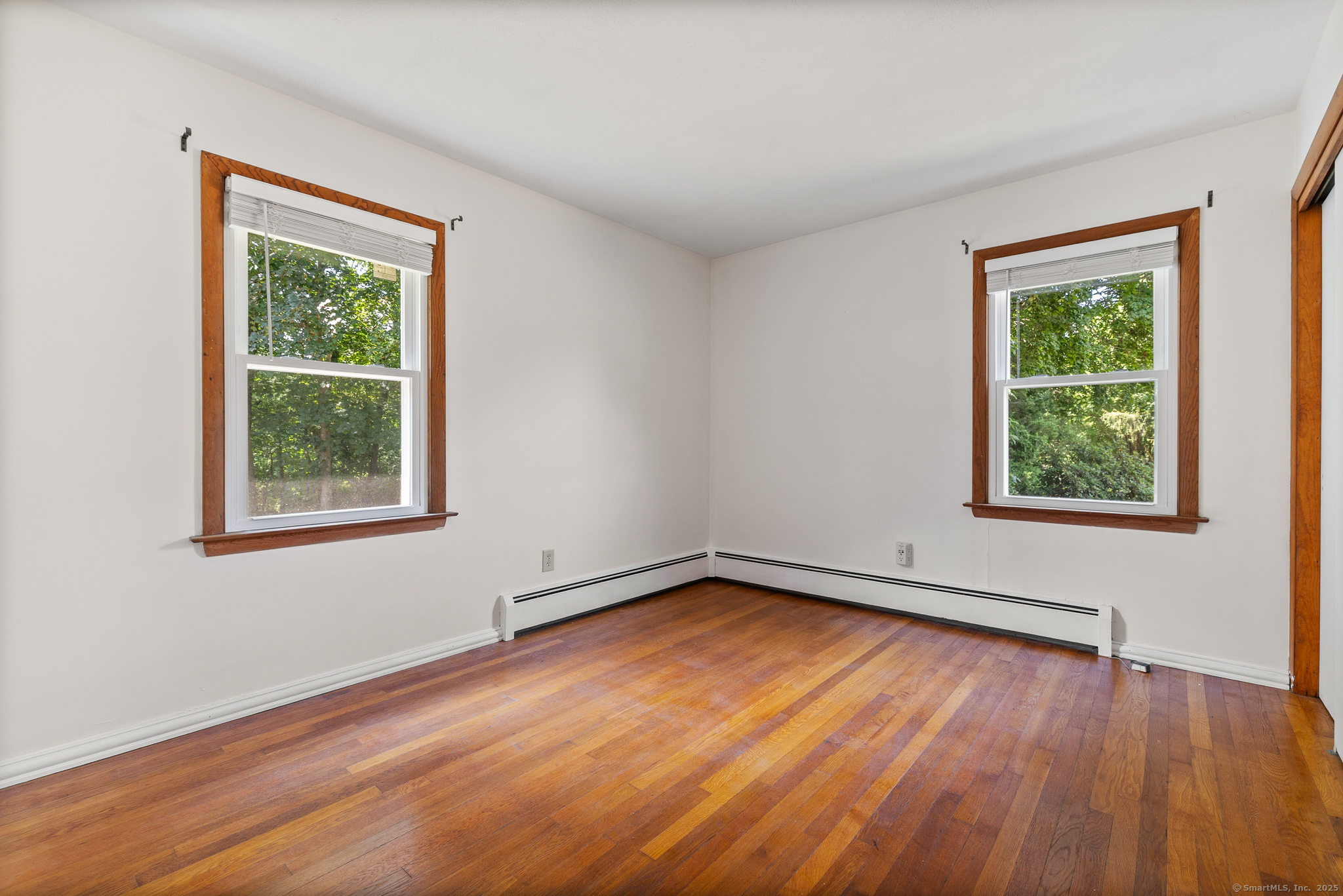 24 Pine Street Waterford, CT 06385 - Photo 4 of 39 a view of an empty room with wooden floor and a window