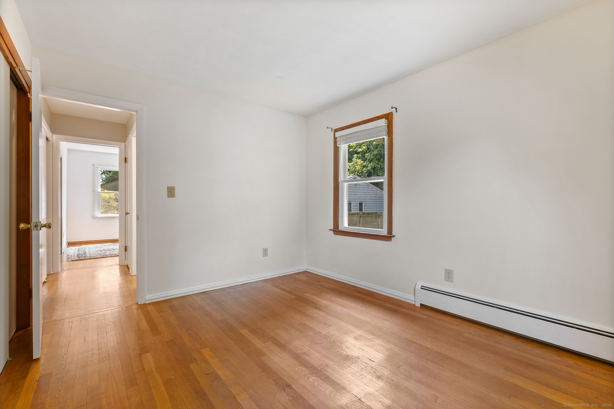 24 Pine Street Waterford, CT 06385 - Photo 5 of 39 a view of empty room with wooden floor and fan
