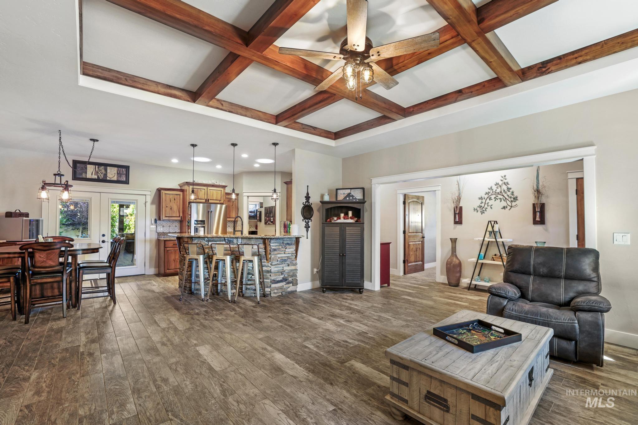 2043 Prospector Way Twin Falls, ID 83301 - Photo 4 of 29 Living area with coffered ceiling, beam ceiling, french doors, dark wood-style floors, and a ceiling fan