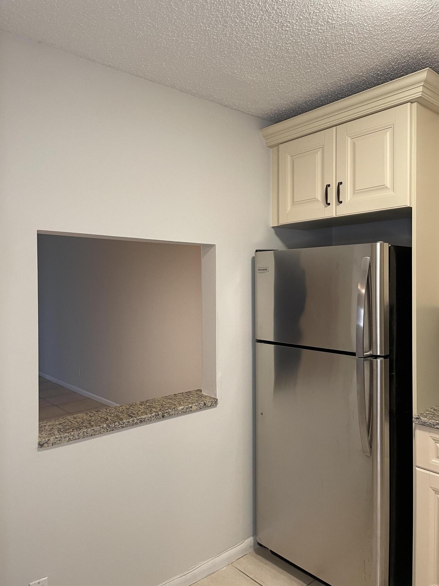 9440 Southwest 8th Street, Unit 217 Boca Raton, FL 33428 - Photo 9 of 28 a refrigerator freezer sitting inside of a kitchen
