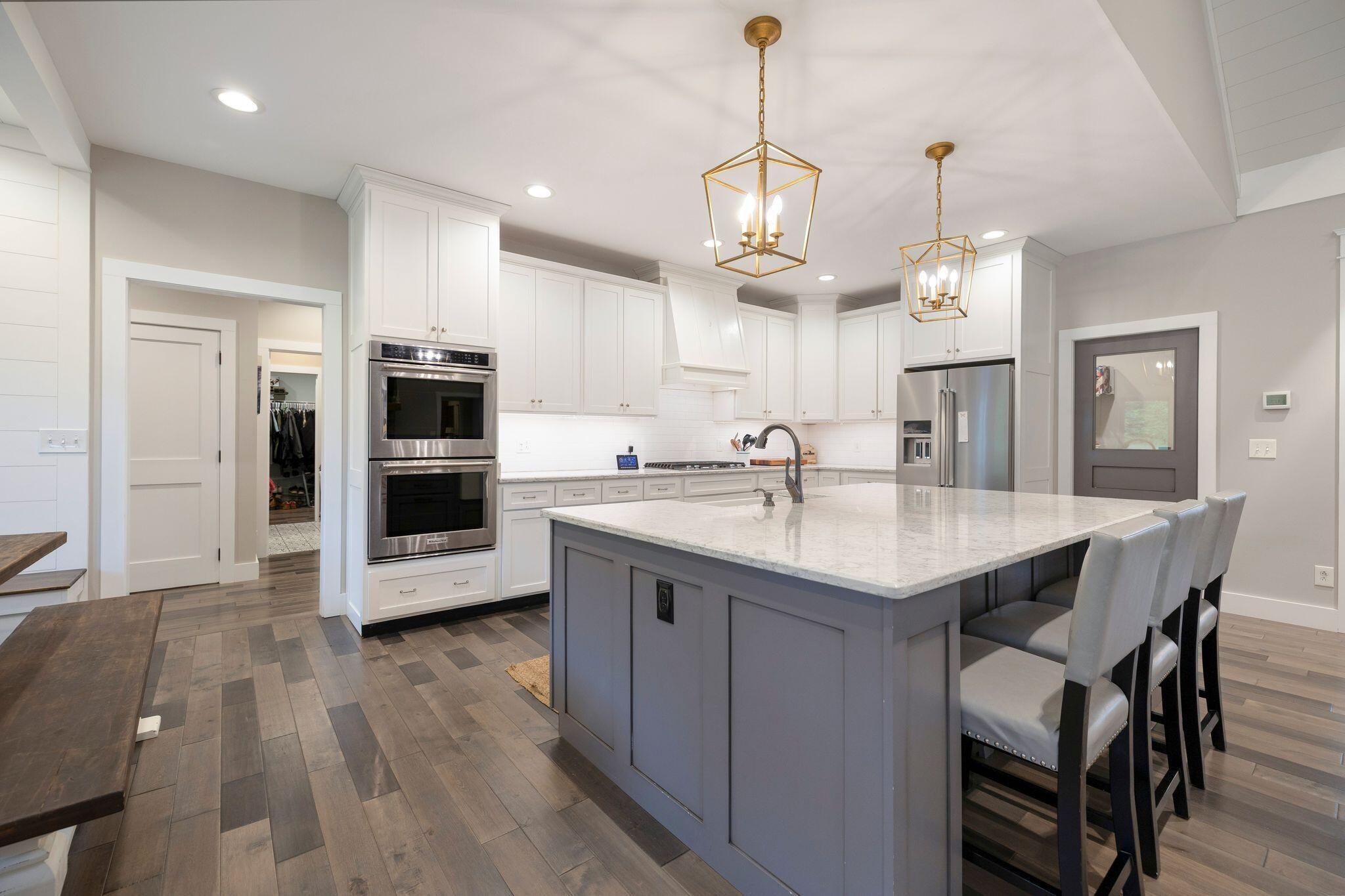 6866 Daus Mountain Road Whitwell, TN 37397 - Photo 4 of 49 a kitchen with stainless steel appliances kitchen island granite countertop a table chairs in it and wooden floors