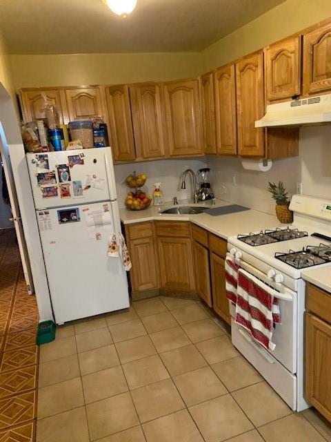 1129 Broadway Brooklyn, NY 11221 - Photo 7 of 15 a kitchen with a sink a stove and cabinets
